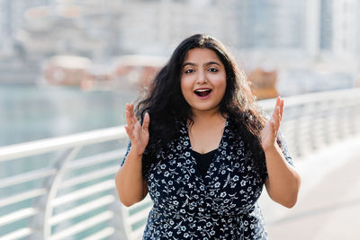 Portrait of a laughing indian woman while walking around the city. positive emotions, cheerful girl.