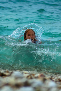 Portrait of girl swimming in the sea