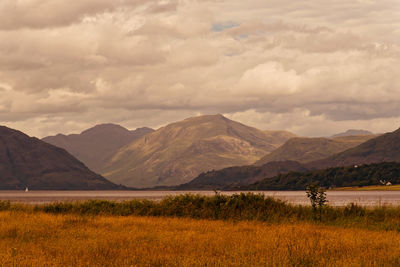 Scenic view of landscape and mountains against sky