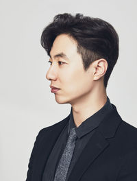 Portrait of young man against white background