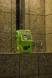 Close-up of telephone booth on wall