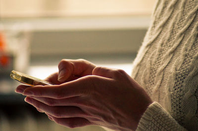 Midsection of woman using mobile phone