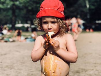 Cute girl eating ice cream on beach