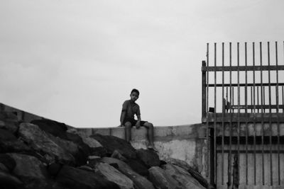Rear view of man standing on rock