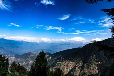 Scenic view of mountains against blue sky