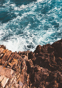 High angle view of rock formations by sea