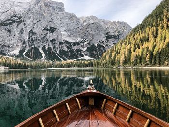 Boat on lake against snowcapped mountain