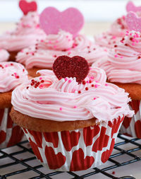 Close-up of cupcakes on pink cake