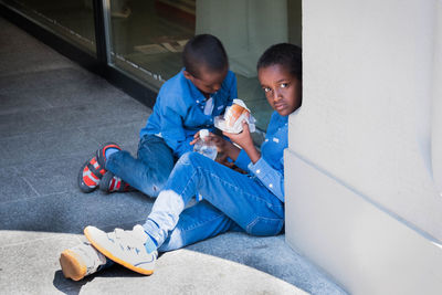 Children playing with toy while sitting on seat