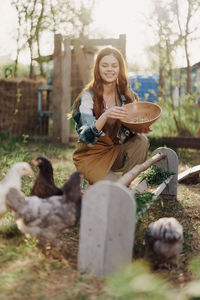 Portrait of young woman sitting on field