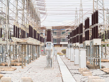 Construction site by buildings against sky in city