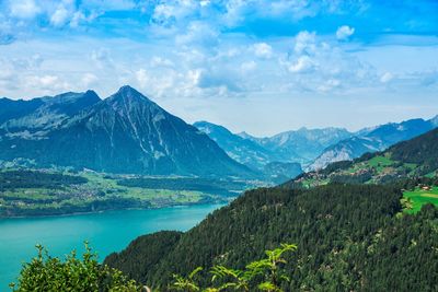 Scenic view of mountains against cloudy sky