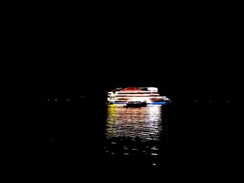 Ship sailing in sea at night