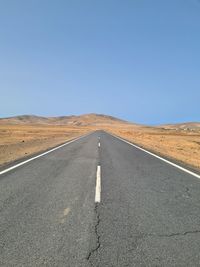 Low angle view of road against clear blue sky