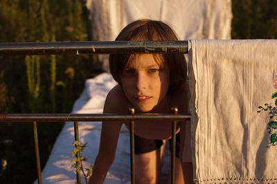 Portrait of teenage girl looking at railing