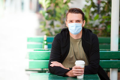 Portrait of young man drinking coffee