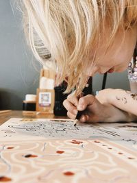 Close-up of girl drawing on table