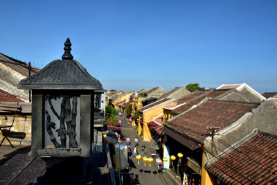 Houses in city against clear blue sky