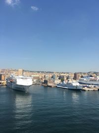 Boats in harbor with buildings in background