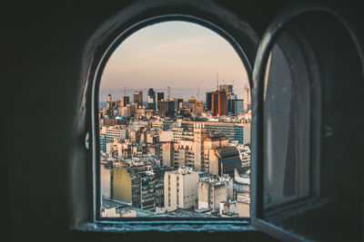 Buildings seen through arch window