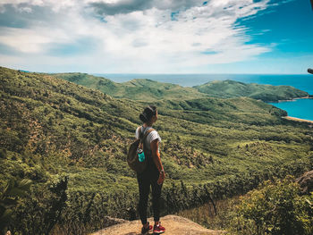 Rear view of man looking at mountain against sky