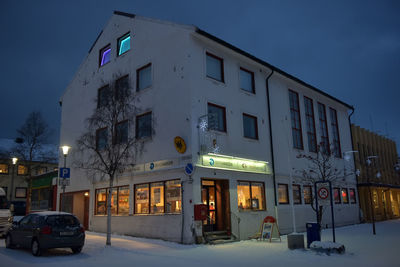 Buildings in city against sky during winter