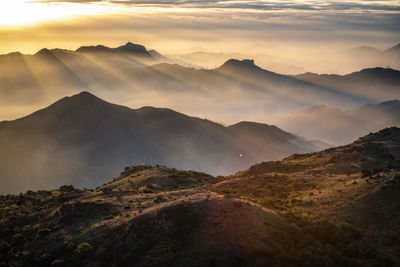 Scenic view of mountains against sky during sunset