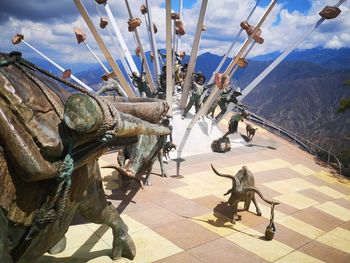 Panoramic view of sculpture and mountains against sky