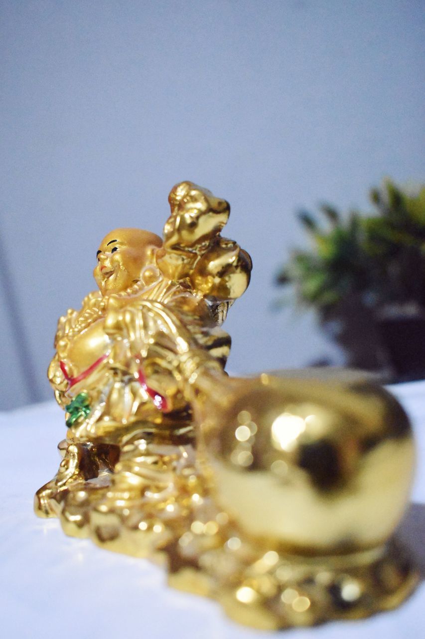 gold, no people, representation, fashion accessory, jewellery, sculpture, wealth, indoors, yellow, close-up, holiday, decoration, figurine, human representation, statue, celebration, christmas, religion