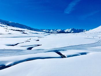 Snow covered mountain against blue sky