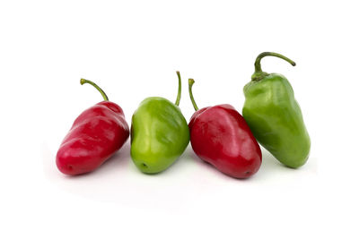 Close-up of red chili peppers against white background
