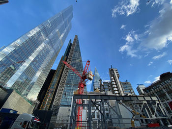 Low angle view of modern buildings against sky in city of london