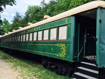 Train on field against trees