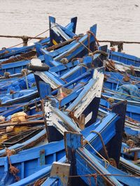 Stack of boats moored at beach