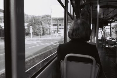 Rear view of woman in train