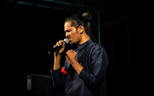 Young man singing on stage