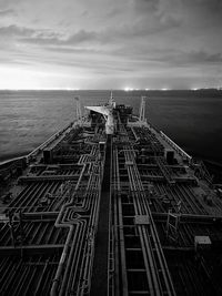 Low angle view of a ship sailing against cloudy sky