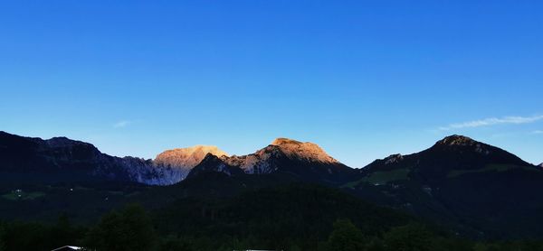 Scenic view of mountains against clear blue sky