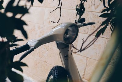 Close-up of bicycle hanging on motorcycle