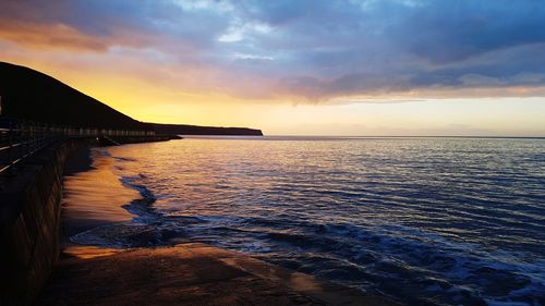 Scenic view of sea against cloudy sky