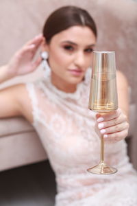 High angle view of young woman drinking glass