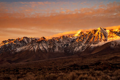 Scenic view of snowcapped mountains against sky during sunset