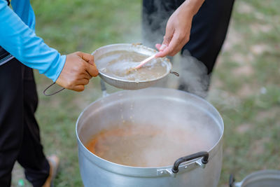 Midsection of man preparing food