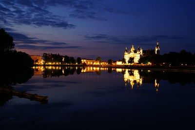 Reflection of illuminated buildings in lake at night