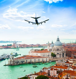 Airplane flying over buildings in city