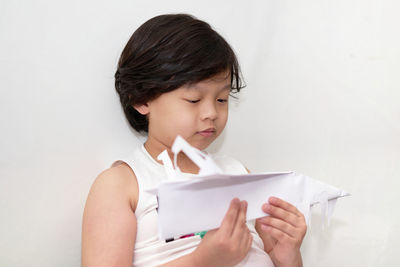 Portrait of a boy play plane paper