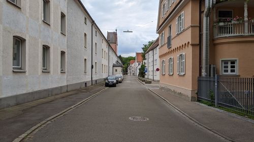 Cars on street amidst buildings in city