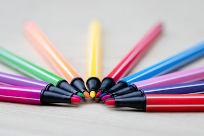 Close-up of multi colored pencils on table