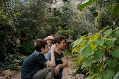 Adventurous family inspecting tropical gallery in botanical garden. local travel