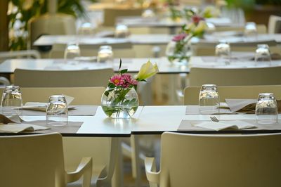 Flower vase on table in restaurant